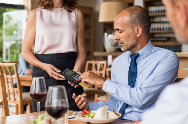 istock Businessman swiping credit card 658610090