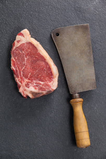 istock Sirloin chop and cleaver against black background 658614240