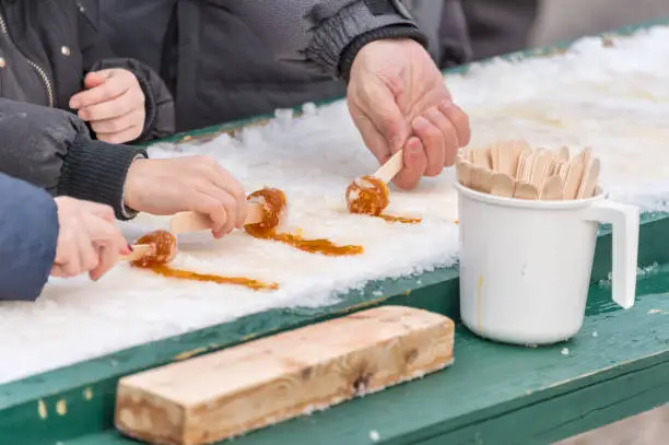 Photo of Maple taffy on snow at the sugar shack, in Montreal, Canada (2017)