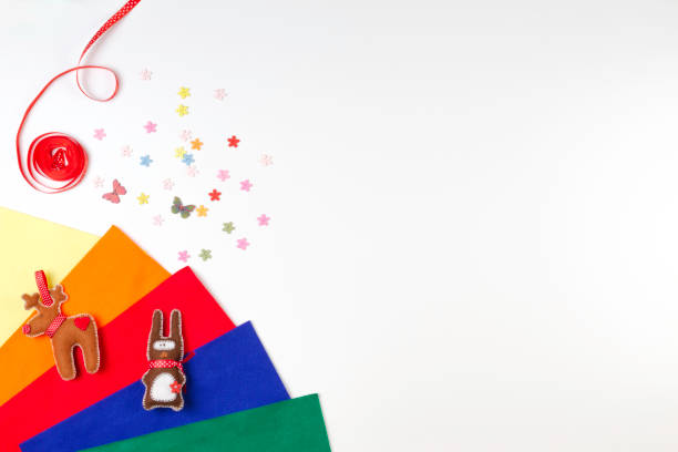 istock Colorful felt, sewing accessories and handmade toys on white background. 658616706
