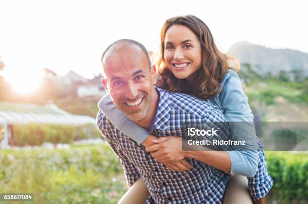 Piggyback Mature Couple Stock Photo - Download Image Now - Couple - Relationship, 40-49 Years, Happiness