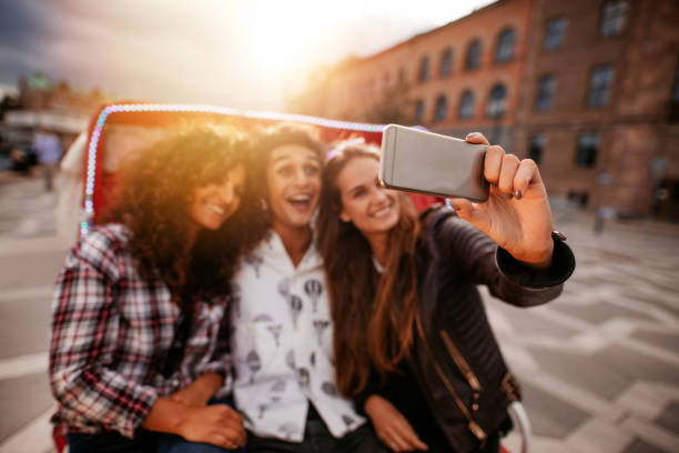 istock Three young friends taking selfie on tricycle ride. 658618196