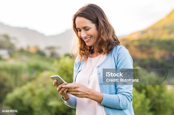 Mature Woman Using Cellphone Stock Photo - Download Image Now - Women, Mobile Phone, Mature Women