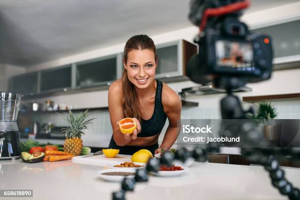 Young Female Blogger Recording Content For Videoblog In Kitchen Stock Photo - Download Image Now