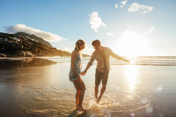 istock Beautiful young couple having fun on beach 658621546