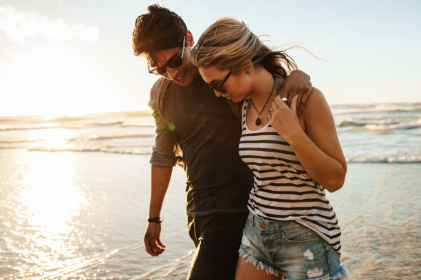 istock Young couple walking on the seashore 658622214