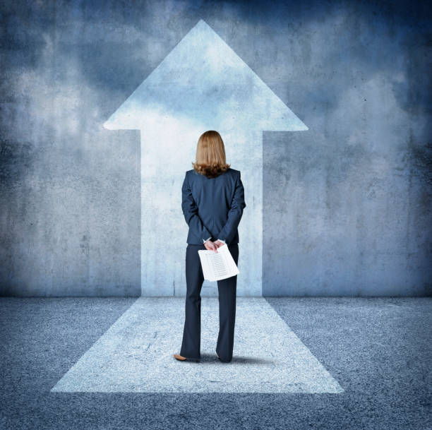 istock Businesswoman Looking Up At Arrow 658624684