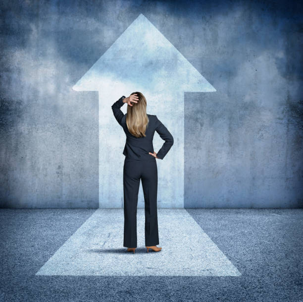 istock Businesswoman Looking Up At Arrow 658624688