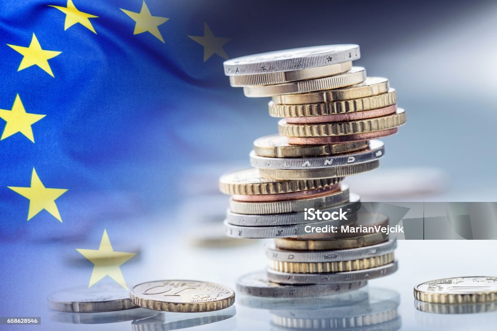 Euro money.Euro Flag.Euro currency.Coins stacked on each other in different positions. European union flag Euro money.Euro Flag.Euro currency.Coins stacked on each other in different positions. European union flag. Currency Stock Photo