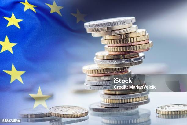 Euro Moneyeuro Flageuro Currencycoins Stacked On Each Other In Different Positions European Union Flag Stock Photo - Download Image Now