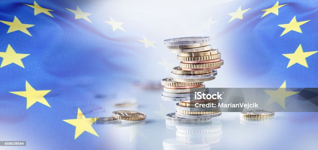 Euro money.Euro Flag.Euro currency.Coins stacked on each other in different positions. European union flag Euro money.Euro Flag.Euro currency.Coins stacked on each other in different positions. European union flag. Coin Stock Photo