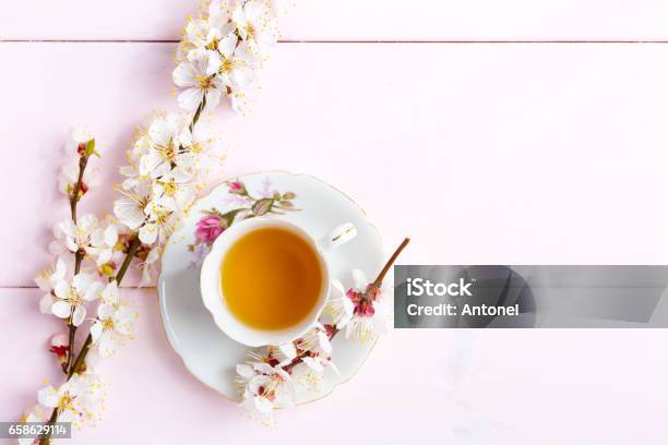Cup Of Tea And Spring Flowers On Light Pink Wooden Table Stock Photo - Download Image Now