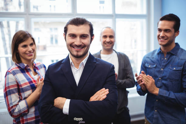 istock Coworkers clapping on businessman 658629314