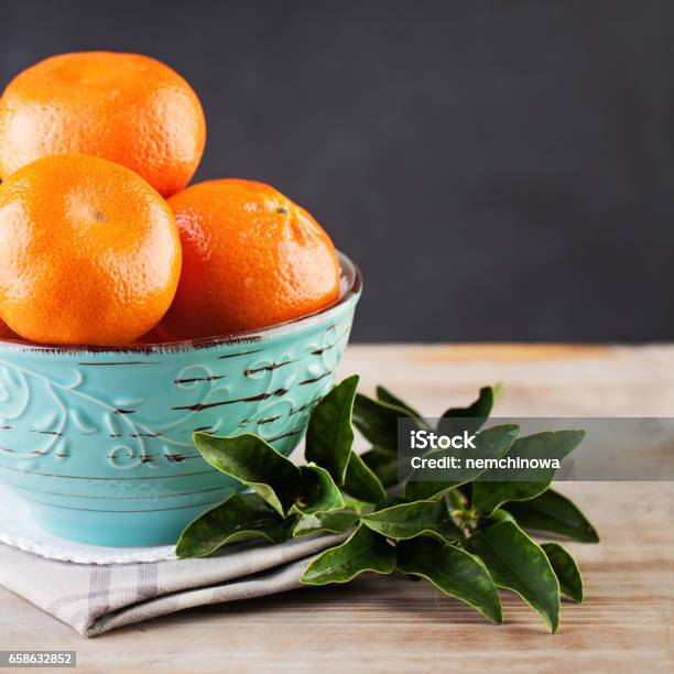 Tangerines With Green Leaves On Kitchen Background Stock Photo - Download Image Now - Chalkboard - Visual Aid, Citrus Fruit, Color Image