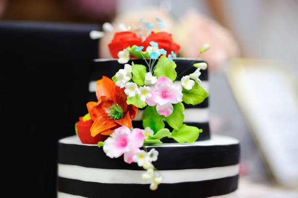 Cake decorated with flowers on a blue background, top view