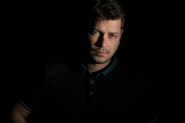istock Young man portrait isolated on black background 658636014