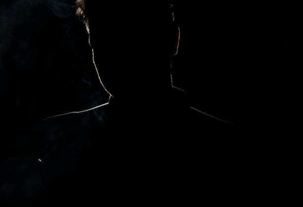 Silhouette of a man in a dark with smoke