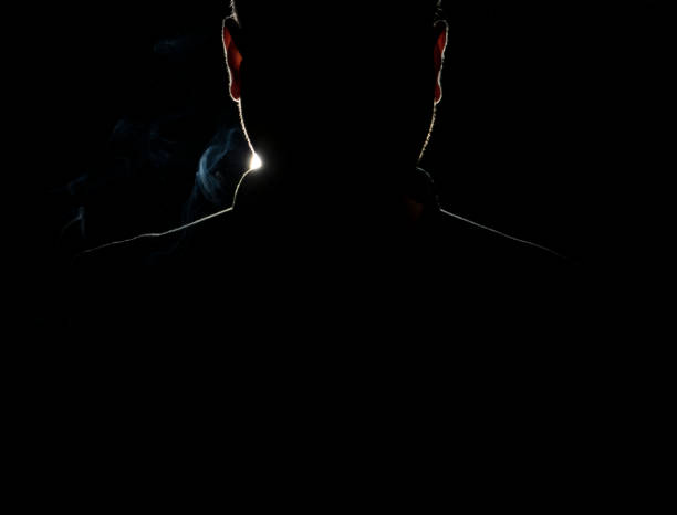 Silhouette of a man in a dark with smoke