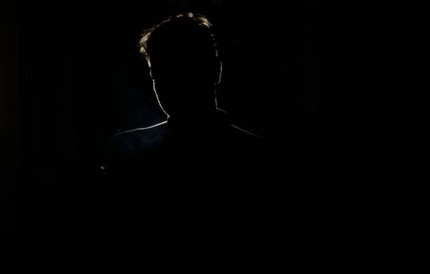 istock Silhouette of a man in a dark with smoke 658638430