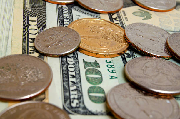 istock US dollars coins and bills. 658640282