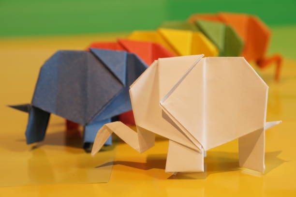 istock Paper origami elephant is isolated on colorful background 658643420