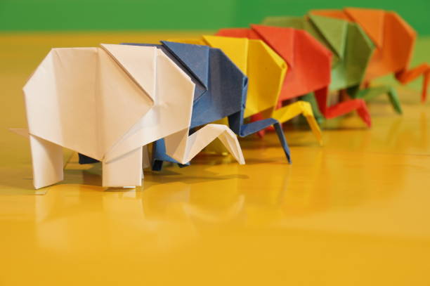 istock Paper origami elephant is isolated on colorful background 658643490