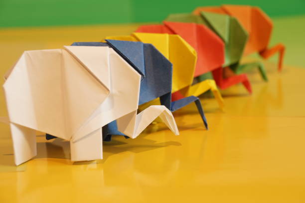 istock Paper origami elephant is isolated on colorful background 658643512