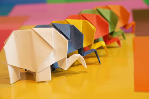 istock Paper origami elephant is isolated on colorful background 658643516