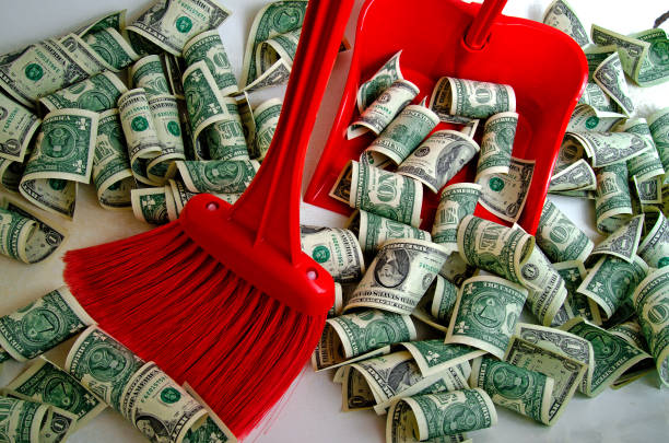 istock Broom sweeping the dollars in the scoop. 658643532