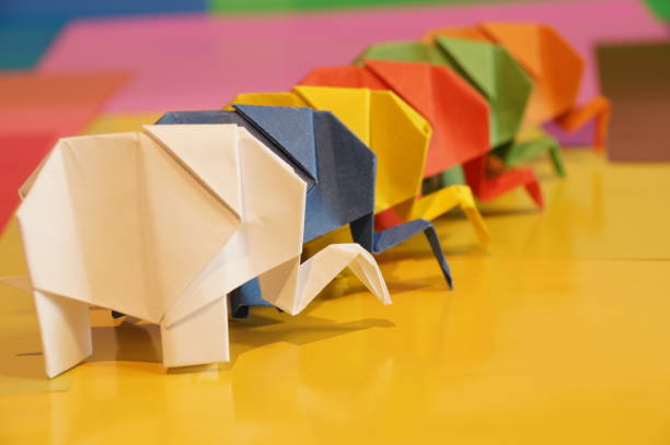 istock Paper origami elephant is isolated on colorful background 658643536