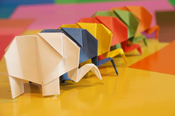 istock Paper origami elephant is isolated on colorful background 658643550