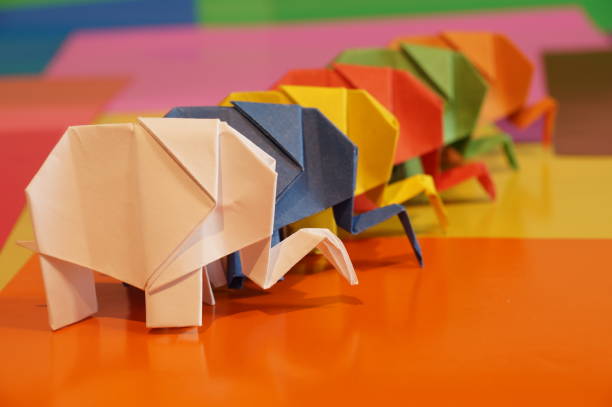 istock Paper origami elephant is isolated on colorful background 658643552