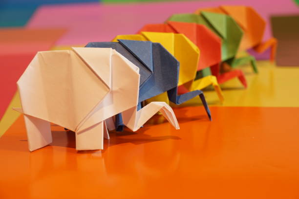 istock Paper origami elephant is isolated on colorful background 658643554