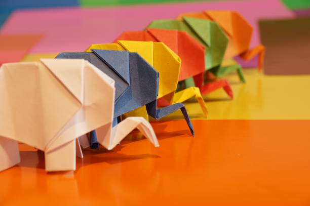 istock Paper origami elephant is isolated on colorful background 658643556
