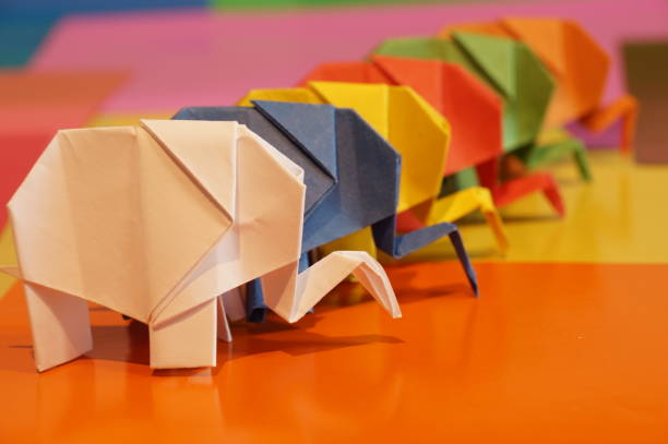istock Paper origami elephant is isolated on colorful background 658643574
