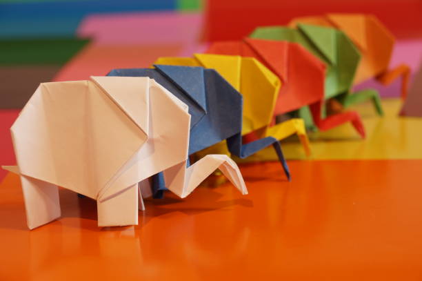 istock Paper origami elephant is isolated on colorful background 658643580