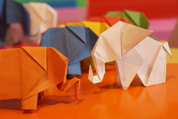 istock Paper origami elephant is isolated on colorful background 658643584