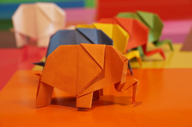 istock Paper origami elephant is isolated on colorful background 658643586