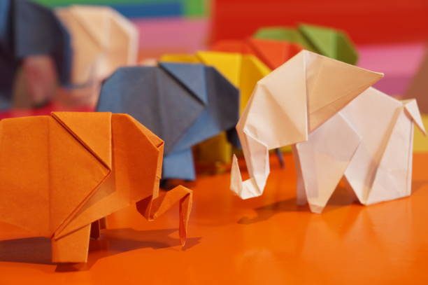 istock Paper origami elephant is isolated on colorful background 658643590