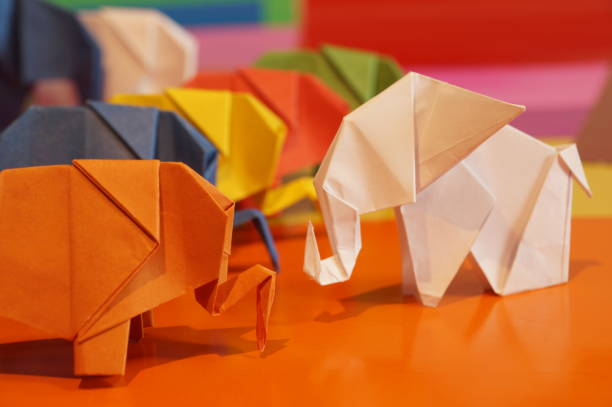 istock Paper origami elephant is isolated on colorful background 658643606