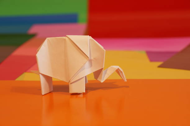 istock Paper origami elephant is isolated on colorful background 658643708