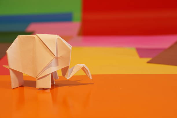 istock Paper origami elephant is isolated on colorful background 658643712