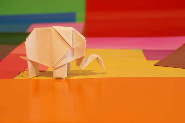 istock Paper origami elephant is isolated on colorful background 658643714