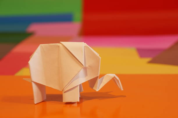 istock Paper origami elephant is isolated on colorful background 658643776