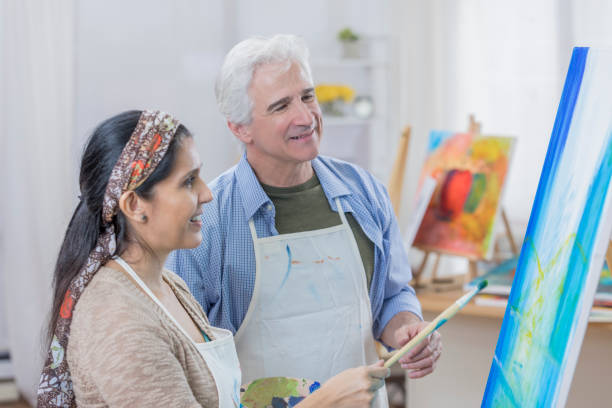 istock Diverse couple paint together in art studio 658645954
