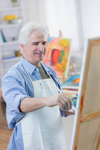 istock Confident senior male artist in his studio 658645962