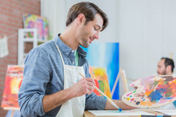 istock Cheerful Caucasian man in art studio 658645972