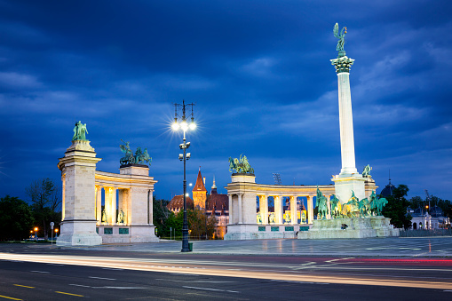 Illuminated view of Hero's Square with a dramatic sky in Budapest at night