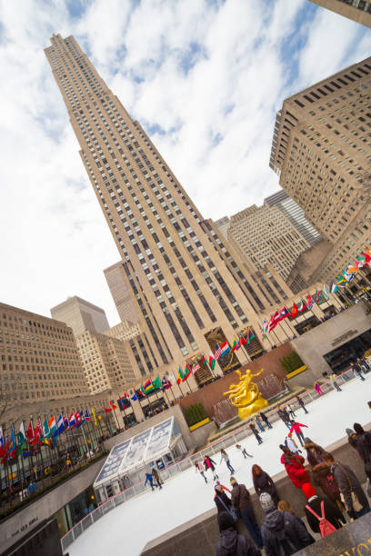 Rockefeller Center skyscraper and ice skate rink on Manhattan, New York City, USA. New York City, USA - March. 2015: New York City landmark, ice skaters and tourists visiting Rockefeller Center ice skate rink on on 24th of March,2015. rockefeller ice rink stock pictures, royalty-free photos & images