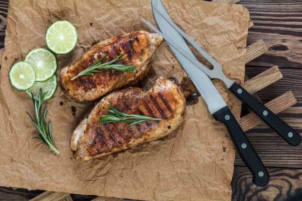 istock Grilled chicken filet with herbs  on a paper 658653138